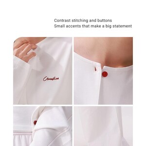 May include: White long-sleeve shirt with red stitching and a red button. The shirt has a small red embroidered logo that says "Стка Май".