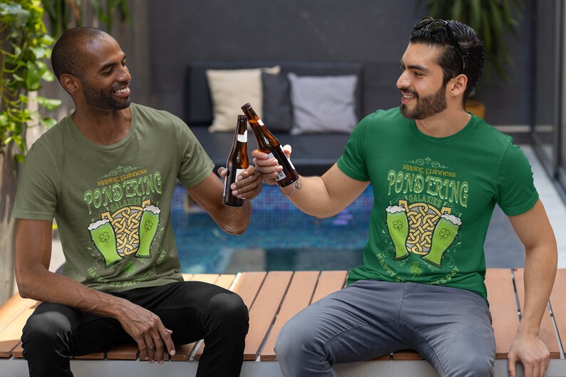 Sipping Guinness, Pondering Galaxies. Happy St. Patrick's day. The Perfect Unisex T-Shirt for the Irish Astrophysics Lover.
