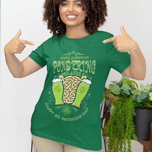 Sipping Guinness, Pondering Galaxies. Happy St. Patrick's day. The Perfect Unisex T-Shirt for the Irish Astrophysics Lover.