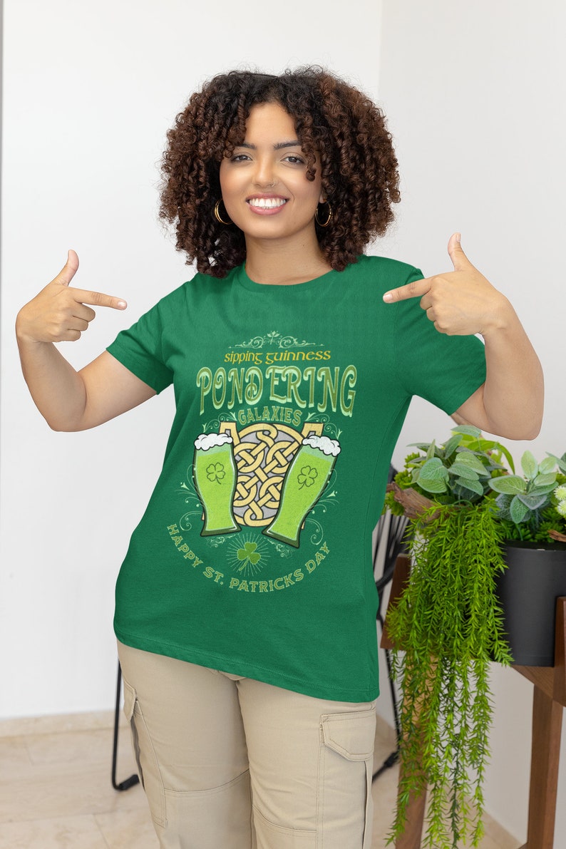 Sipping Guinness, Pondering Galaxies. Happy St. Patrick's day. The Perfect Unisex T-Shirt for the Irish Astrophysics Lover.