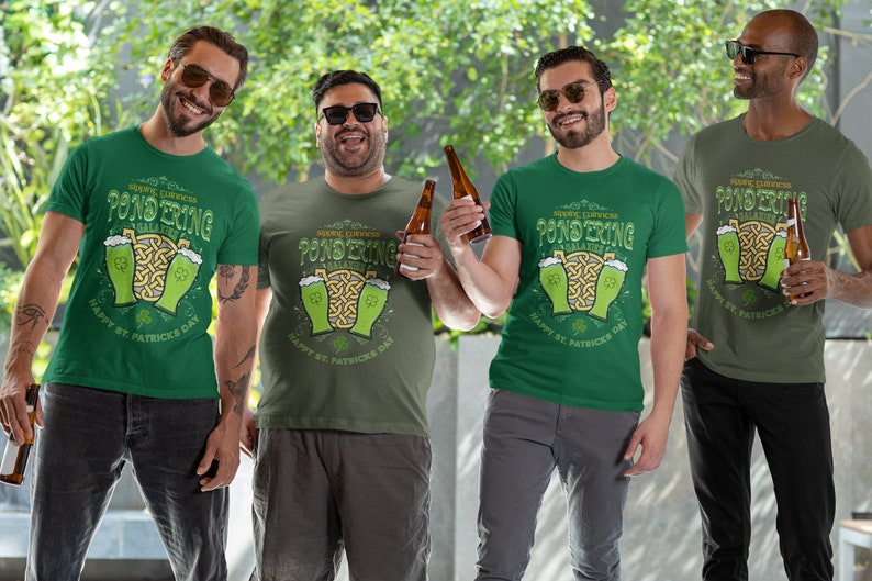 Sipping Guinness, Pondering Galaxies. Happy St. Patrick's day. The Perfect Unisex T-Shirt for the Irish Astrophysics Lover.