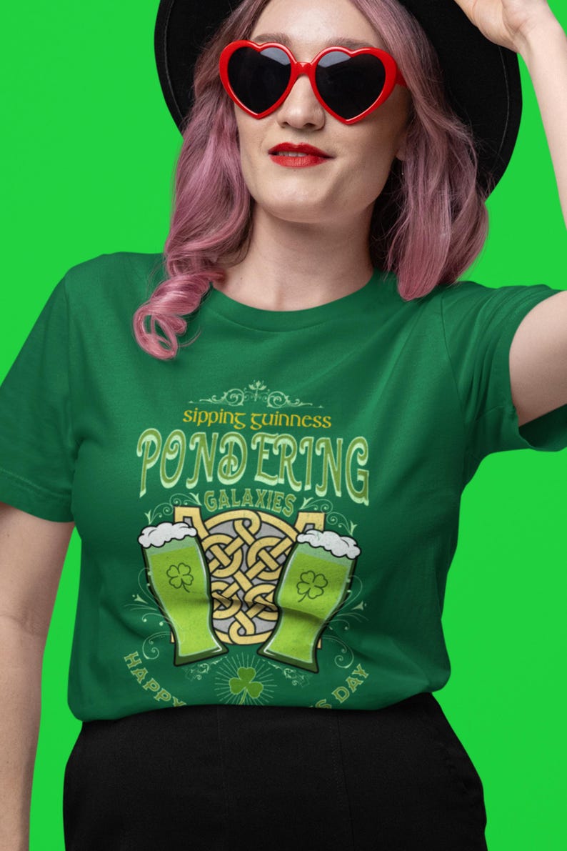 Sipping Guinness, Pondering Galaxies. Happy St. Patrick's day. The Perfect Unisex T-Shirt for the Irish Astrophysics Lover.