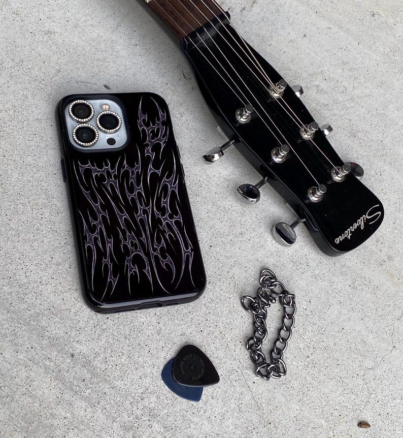 Black phone case with cyber cigilism designs that look chrome silver and metal to create an edgy gothic design