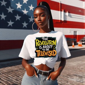 May include: White t-shirt with a yellow and black graphic print that says "The Revolution is About to Be Televised".