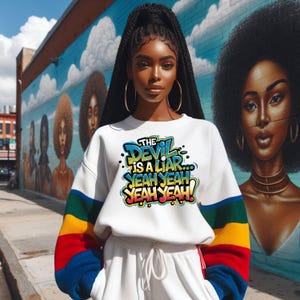 May include: A white sweatshirt with rainbow colored sleeves and the text "THE DEVIL IS A LIAR...YEAH YEAH YEAH YEAH!" printed on the front.