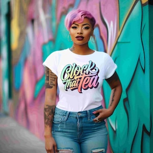 May include: White t-shirt with the text "Clock That Tea" in a colorful, gradient font. The shirt is paired with blue jeans. The background features a colorful graffiti mural.