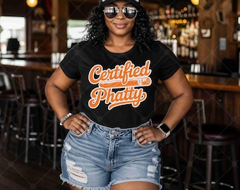 May include: Black t-shirt with the words "Certified Phatty" in orange script and a cigar graphic. The person is wearing a white and black trucker hat with the words "Certified Phatty" and sunglasses.