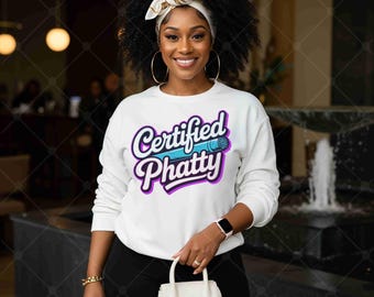 May include: White sweatshirt with the text "Certified Phatty" in a purple and blue design. The sweatshirt is paired with black pants and a small white purse. The person is wearing a white headband and gold hoop earrings.