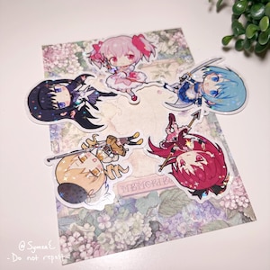 May include: Five holographic stickers featuring anime characters. The stickers are on a white background with a floral pattern. The characters are all girls with different colored hair and outfits. The stickers are all in a chibi style, which is a Japanese style of drawing characters with large heads and small bodies.