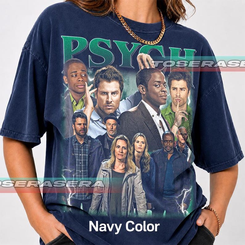 May include: A navy blue short-sleeve t-shirt featuring a large graphic print of the cast of the television show Psych. The design includes the word Psych in large green letters at the top, surrounded by lightning effects and multiple character portraits.