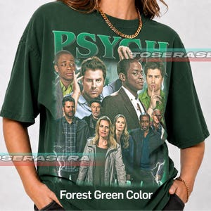 May include: A dark forest green short-sleeve t-shirt featuring a large graphic print of the cast from the television show Psych. The design includes the word Psych in bold green letters at the top and a collage of characters below.