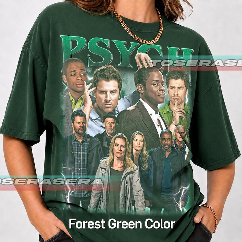 May include: A dark forest green short-sleeve t-shirt featuring a large graphic print of the cast from the television show Psych. The design includes the word Psych in bold green letters at the top and a collage of characters below.