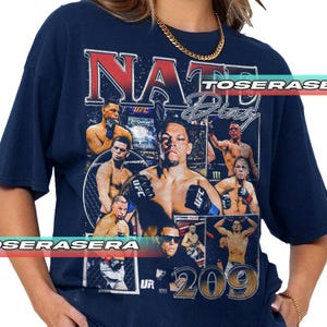 May include: A navy blue short-sleeve t-shirt featuring a large graphic print of Nate Diaz. The design includes multiple photographic panels of the fighter in action, the text NATE DIAZ in bold lettering, and the number 209 in large gold font.