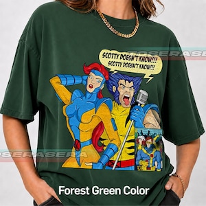 May include: A forest green t-shirt featuring a graphic of two comic book characters, one with red hair and one with blue hair, singing into a microphone. A yellow speech bubble above them contains the text, SCOTTY DOESN'T KNOW!!!