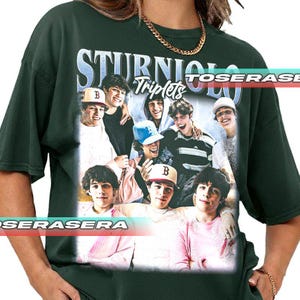 May include: Dark green t-shirt featuring a graphic of a group of young men with the text "STURNIOLO Triplets" in a stylized font. The image includes the word "TOSERASE" in a horizontal band across the top.
