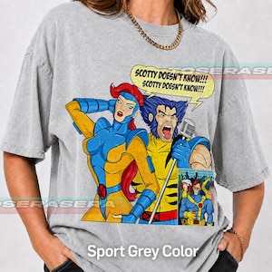 May include: A grey t-shirt featuring a graphic of X-Men characters Jean Grey and Wolverine. Wolverine holds a microphone and sings, with a speech bubble above reading, "SCOTTY DOESN'T KNOW!!! SCOTTY DOESN'T KNOW!!!" A small comic panel is included below.