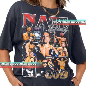 May include: A charcoal gray short-sleeve t-shirt featuring a graphic collage of mixed martial artist Nate Diaz. The design includes multiple action photos, the text NATE DIAZ in bold lettering, and the large number 209 at the bottom.