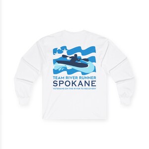 May include: White long-sleeve shirt featuring a blue graphic of a kayaker on water with the text "TEAM RIVER RUNNER SPOKANE Veterans on the River to Recovery". The shirt has a crew neck and long sleeves.