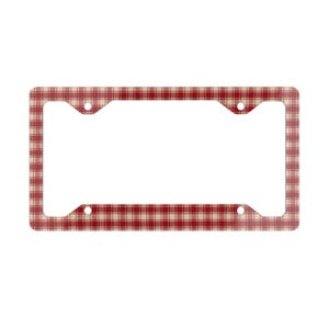 May include: License plate frame with a red and beige plaid pattern. The frame has four mounting holes and a rectangular opening for the license plate. The plaid design is a classic, country-style pattern.