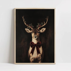 May include: A painting of a deer with a red velvet bow tie and holly berries on its antlers against a dark background.