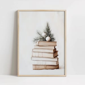May include: A stack of beige books with a small sprig of green foliage and white ornaments on top. The books are arranged in a stack with the top book being the largest. The background is a light beige color.