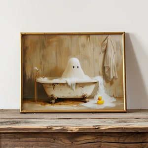 May include: A framed painting of a ghost taking a bath in a vintage bathtub with a yellow rubber ducky floating in the water. The ghost has two eyes and is wearing a white sheet. The bathtub is white with gold accents and is sitting on four legs. The background is a wooden wall with a towel hanging on a hook.