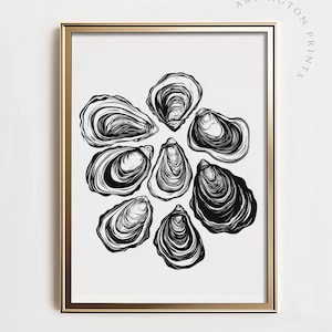 May include: A framed art print featuring a cluster of stylized black and white oyster shell illustrations. The artwork is set against a white background and framed in a gold-colored frame. The text "ARLINGTON PRINTS" is printed in a curved arc in the upper right corner.