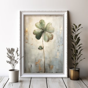 May include: A framed painting of a green four-leaf clover on a textured background with gold accents.
