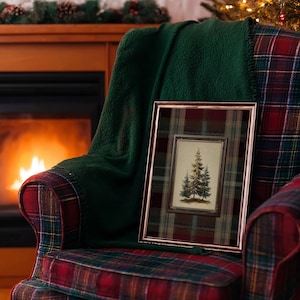 Vintage pine tree painting surrounded by a red, green, and gold tartan plaid border, rustic Christmas wall art for lodge or farmhouse holiday decor.