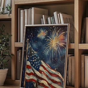 May include: A framed painting of an American flag waving in the wind with fireworks exploding in the night sky. The flag is red, white, and blue with stars on the blue field. The fireworks are yellow, orange, and red.