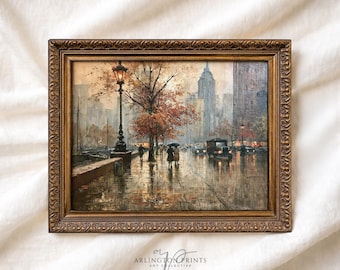 May include: A framed oil painting depicting a rainy city street scene with a tall lamppost, a large tree with autumn-colored leaves, pedestrians with umbrellas, and a vintage car. The artwork is enclosed in an ornate, dark gold-toned frame.