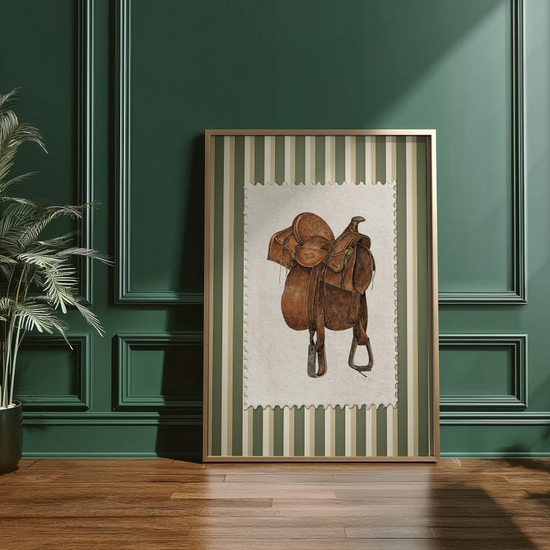 Printed Western wall art featuring a detailed illustration of a vintage leather cowboy saddle with stirrups, displayed on textured parchment-style paper with a striped green and cream background. Ideal for rustic home decor, ranch houses, barns, or cowboy-themed rooms. This artwork evokes classic Western heritage and equestrian charm, making it a perfect printed piece for lovers of country and cowboy style.