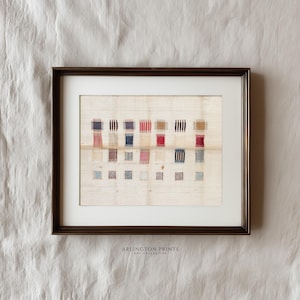 May include: Framed artwork featuring a grid of colorful woven squares in red, blue, and tan hues. The artwork is set against a cream-colored background and framed in a dark brown frame. The text "ARLINGTON PRINTS ART COLLECTIVE" is printed at the bottom.
