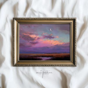 May include: A framed landscape painting with a gold ornate frame. The artwork depicts a sunset with a crescent moon in a vibrant sky of pink, purple, and orange hues. The text "ARLINGTON PRINTS ART COLLECTIVE" is visible in the bottom right corner.