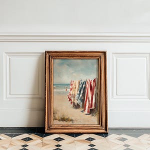 Beach scene with red, white, and blue towels hanging on a wooden fence, ocean waves and swimmers in the background. Coastal Americana style perfect for summer or 4th of July decor. Patriotic Beachy Wall Art, Coastal 4th of July PRINTABLE, Red White Blue Beach Towels, Vintage Summer Seaside Decor, Retro Americana Print