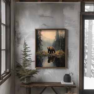 ustic wilderness-themed gallery wall featuring digital paintings of a bear by a lake, a crow on a branch, deer in misty woods, a cabin by the water, a leaping fish, and a foggy forest. Earthy tones and moody lighting create a serene, nature-inspired aesthetic perfect for lodge, cabin, or modern rustic decor.