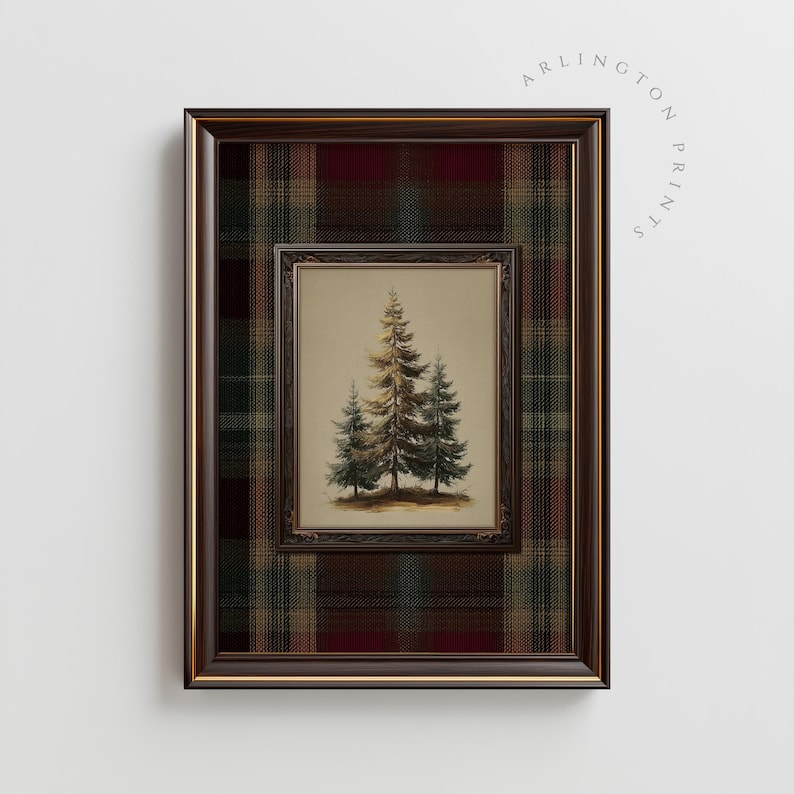 May include: A framed print featuring a watercolor painting of three evergreen trees. The inner frame is a dark brown, and the outer frame is a plaid pattern in shades of red, green, and brown. The text "ARLINGTON PRINTS" is visible.