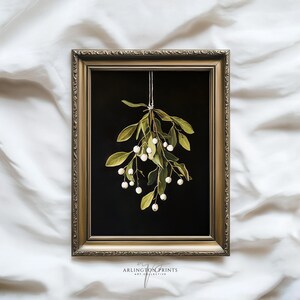 Printable mistletoe wall art with green leaves and white berries on a dark background, vintage rustic Christmas holiday print.