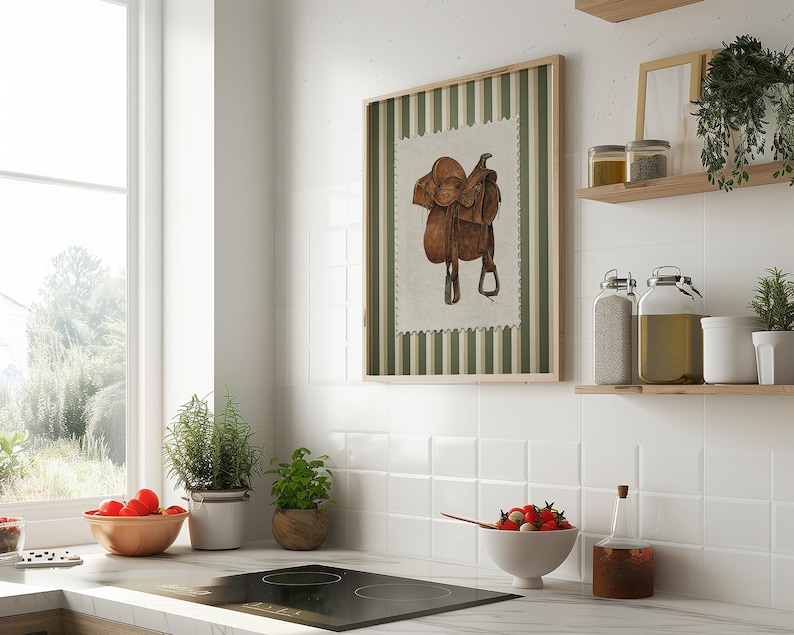 Printed Western wall art featuring a detailed illustration of a vintage leather cowboy saddle with stirrups, displayed on textured parchment-style paper with a striped green and cream background. Ideal for rustic home decor, ranch houses, barns, or cowboy-themed rooms. This artwork evokes classic Western heritage and equestrian charm, making it a perfect printed piece for lovers of country and cowboy style.