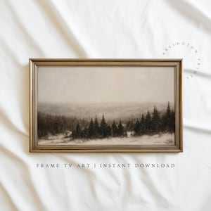 May include: A framed landscape print featuring a winter forest scene with evergreen trees and a misty sky. The artwork is in a gold-colored frame. The text "FRAME TV ART | INSTANT DOWNLOAD" is at the bottom of the image.
