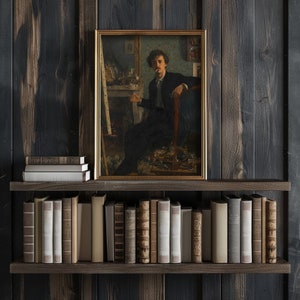 May include: A framed painting of a man sitting in a chair, holding a cigarette, with a dark background and a wooden shelf with books below.