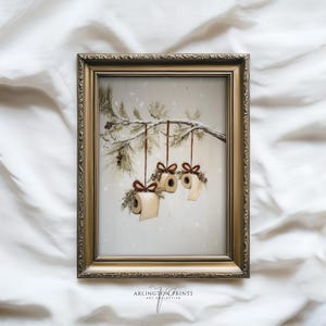 Funny Christmas bathroom print featuring toilet paper ornaments with red bows and greenery on a snowy pine branch, humorous holiday wall art digital download.