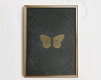 May include: A gold butterfly illustration on a dark green background with an ornate gold frame. The butterfly is centered in the image and has a detailed design.