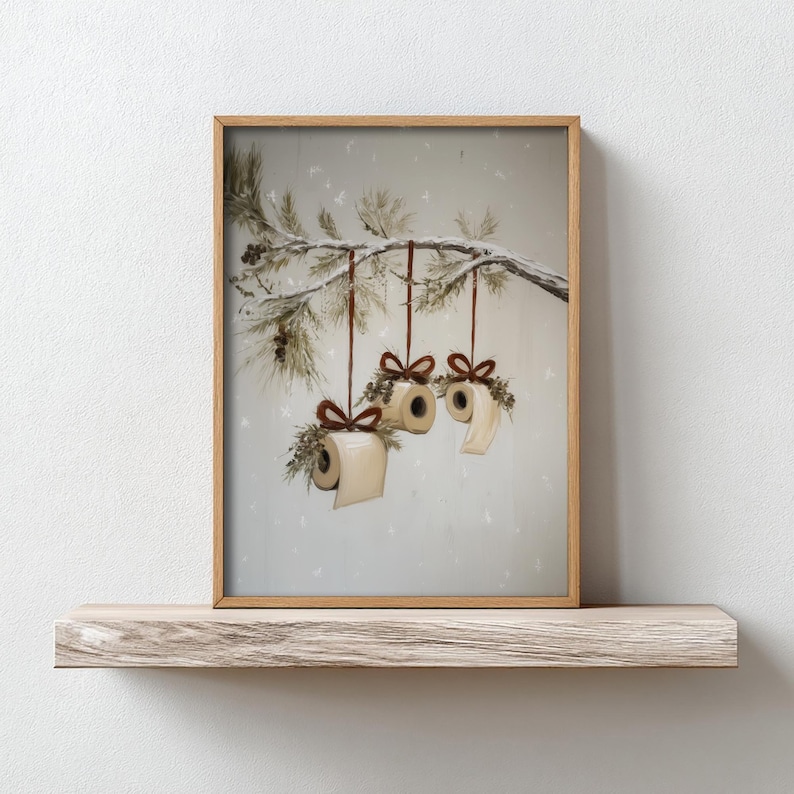 Funny Christmas bathroom print featuring toilet paper ornaments with red bows and greenery on a snowy pine branch, humorous holiday wall art digital download.