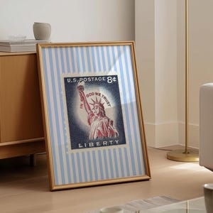Vintage U.S. postage stamp wall art featuring the Statue of Liberty with patriotic colors and retro background, perfect for 4th of July or Americana decor.