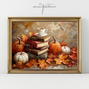 May include: A still life painting of a stack of old books, two pumpkins, a white pumpkin, and a cup of coffee on a table with autumn leaves scattered around. The painting is framed in a gold frame.