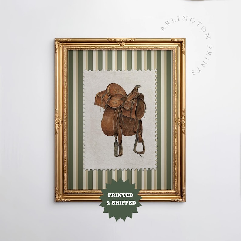 Printed Western wall art featuring a detailed illustration of a vintage leather cowboy saddle with stirrups, displayed on textured parchment-style paper with a striped green and cream background. Ideal for rustic home decor, ranch houses, barns, or cowboy-themed rooms. This artwork evokes classic Western heritage and equestrian charm, making it a perfect printed piece for lovers of country and cowboy style.