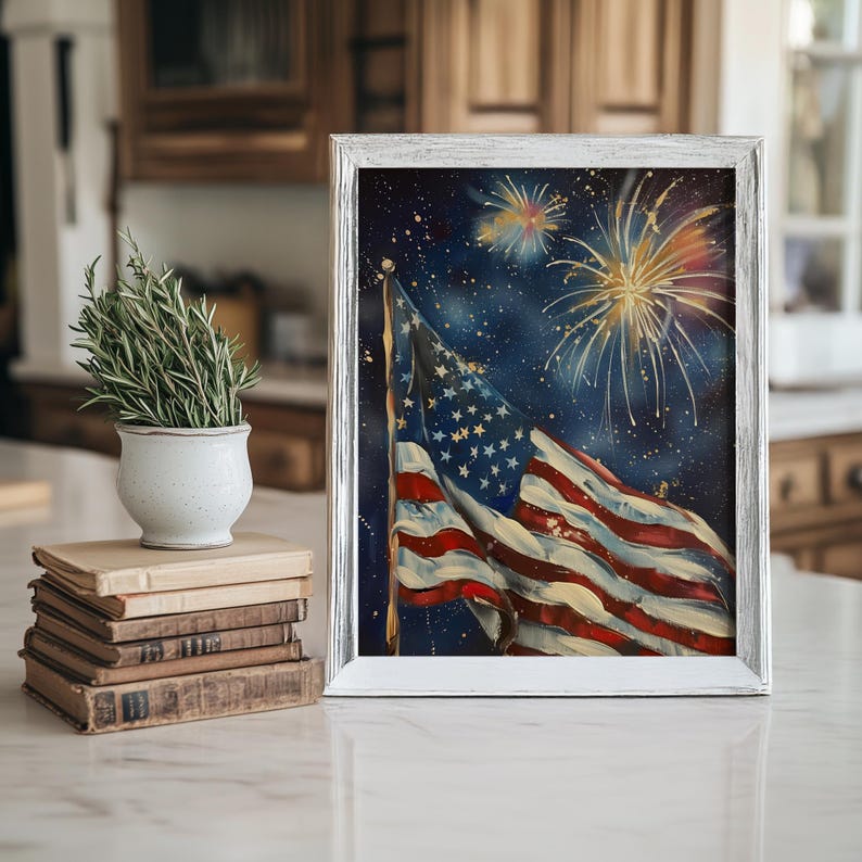 May include: A framed painting of an American flag waving in the wind against a dark blue background with white stars and gold fireworks.