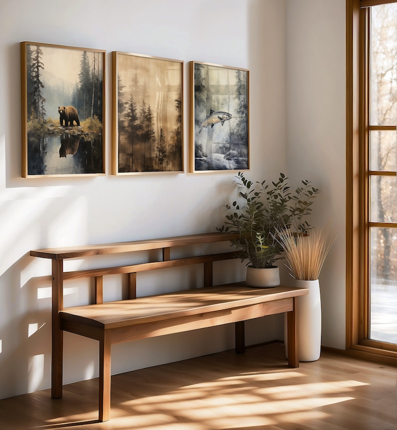 ustic wilderness-themed gallery wall featuring digital paintings of a bear by a lake, a crow on a branch, deer in misty woods, a cabin by the water, a leaping fish, and a foggy forest. Earthy tones and moody lighting create a serene, nature-inspired aesthetic perfect for lodge, cabin, or modern rustic decor.