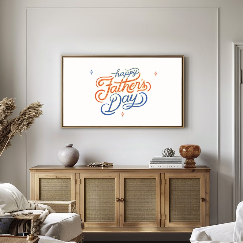 May include: A framed art print with the words "Happy Father's Day" in orange and blue script. The artwork is displayed above a wooden cabinet with woven door panels. Decorative items include a vase and a small sculpture.
